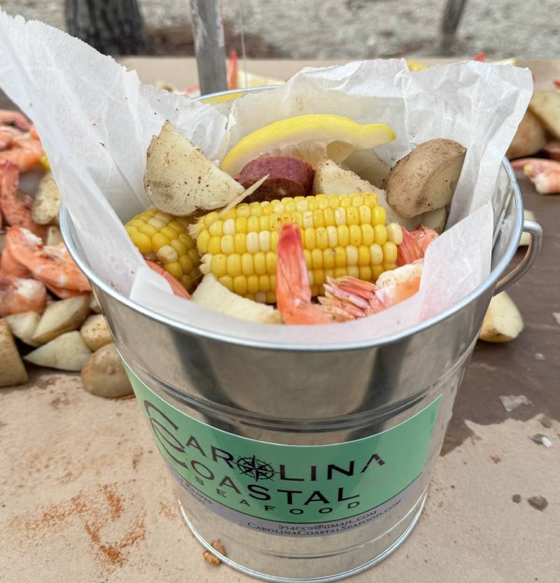 a large metal bucket filled with a variety of food items